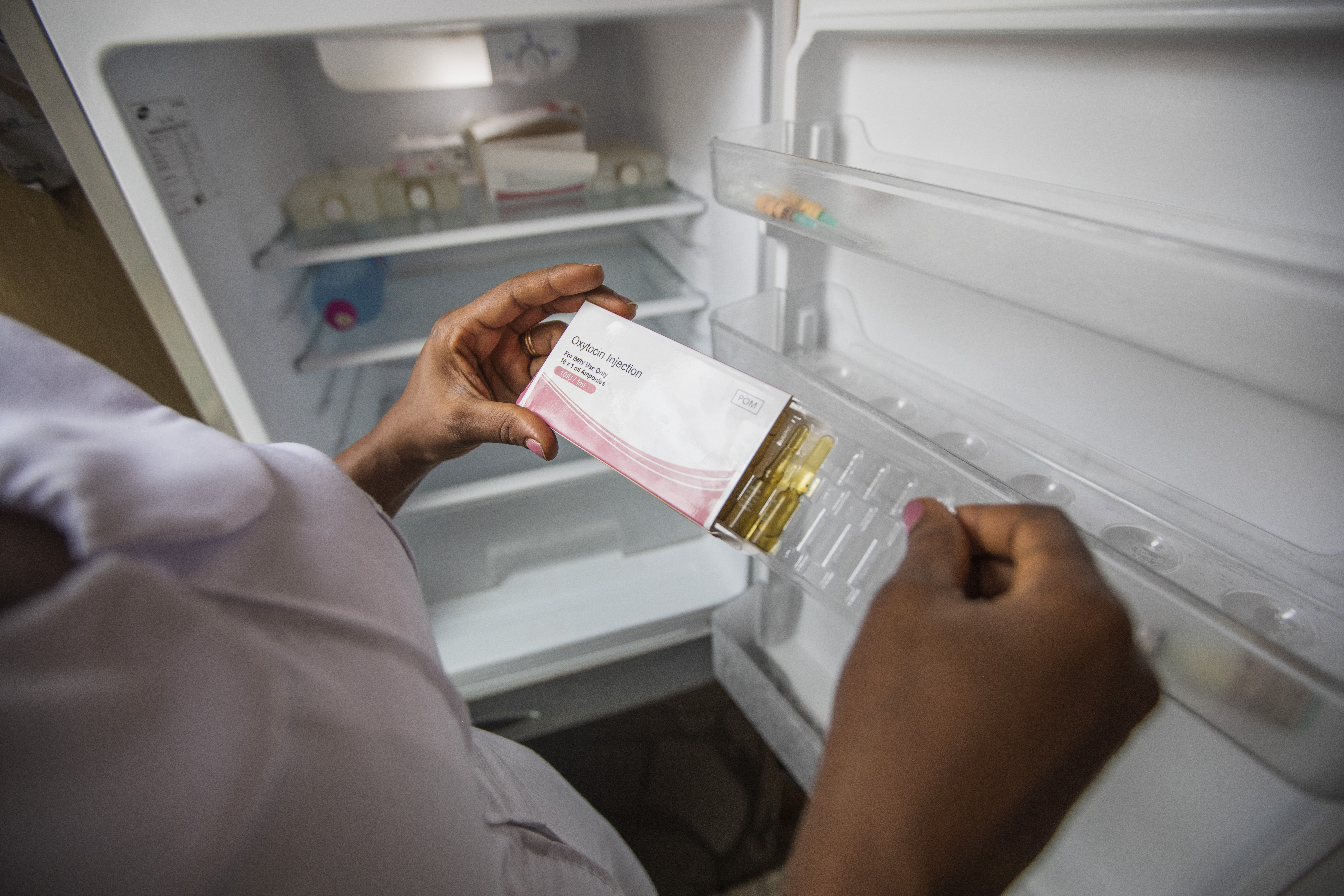 midwife holds temperature-controlled oxytocin package