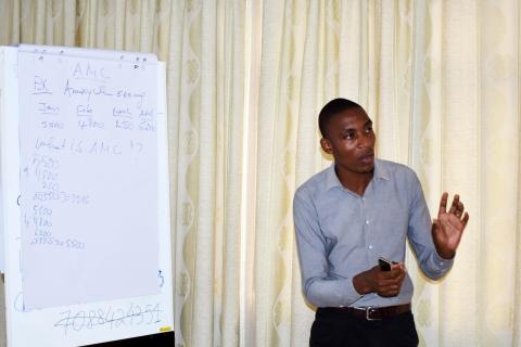 Munezero Aimable, Ruhengeri Referral Hospital pharmacist demonstrating how to calculate average monthly consumption of commodities.